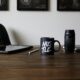 Work desk with a mug that says "Hustle"